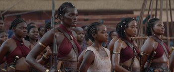 Movie still from “The Woman King” (2022), directed by Gina Prince-Bythewood – A group of people standing next to each other; Medium shot, Low angle