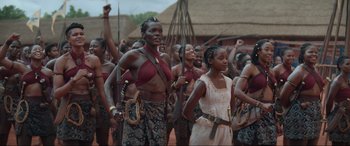 Movie still from “The Woman King” (2022), directed by Gina Prince-Bythewood – A group of people standing next to each other; Medium shot, Low angle