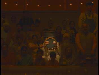 Movie still from “The Wonderful Story of Henry Sugar” (2023), directed by Wes Anderson – A group of people in a room at night; Wide shot, High angle