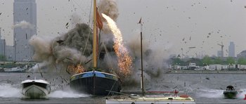 Movie still from “The World Is Not Enough” (1999), directed by Michael Apted – A boat is in the water with a lot of smoke coming out of it; Extreme Wide shot, Low angle
