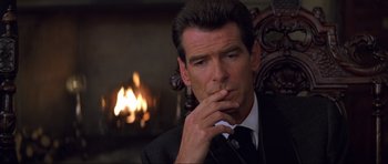 Movie still from “The World Is Not Enough” (1999), directed by Michael Apted – A person wearing a suit and tie; Close Up shot, Over the shoulder angle