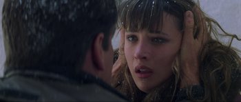 Movie still from “The World Is Not Enough” (1999), directed by Michael Apted – A woman's face as a man looks on; Close Up shot, Over the shoulder angle