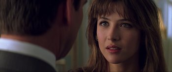 Movie still from “The World Is Not Enough” (1999), directed by Michael Apted – A woman's face as a man looks on; Close Up shot, Over the shoulder angle
