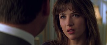 Movie still from “The World Is Not Enough” (1999), directed by Michael Apted – A person looking at the camera; Close Up shot, Over the shoulder angle