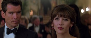 Movie still from “The World Is Not Enough” (1999), directed by Michael Apted – A person wearing a suit and tie; Close Up shot, Over the shoulder angle