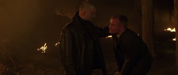 Movie still from “The World Is Not Enough” (1999), directed by Michael Apted – Two men in leather jackets one of whom is touching the other's face; Close Up shot, Over the shoulder angle