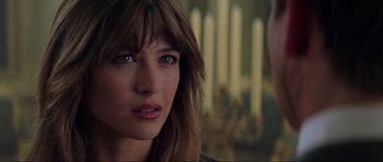 Movie still from “The World Is Not Enough” (1999), directed by Michael Apted – A woman's face with candles in the background; Close Up shot, Over the shoulder angle