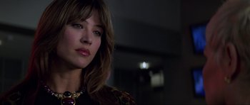 Movie still from “The World Is Not Enough” (1999), directed by Michael Apted – A person wearing a necklace; Close Up shot, Low angle