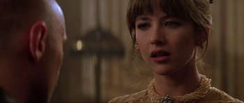 Movie still from “The World Is Not Enough” (1999), directed by Michael Apted – A person wearing a necklace; Close Up shot, Over the shoulder angle