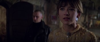 Movie still from “The World Is Not Enough” (1999), directed by Michael Apted – A man and a woman standing next to each other; Close Up shot, Over the shoulder angle