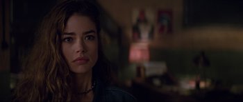 Movie still from “The World Is Not Enough” (1999), directed by Michael Apted – A person wearing a necklace; Close Up shot, Over the shoulder angle