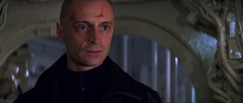 Movie still from “The World Is Not Enough” (1999), directed by Michael Apted – A person wearing a black jacket; Close Up shot, Low angle