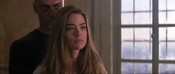 Movie still from “The World Is Not Enough” (1999), directed by Michael Apted – A woman with long brown hair and blue eyes looking to her left; Close Up shot, Over the shoulder angle