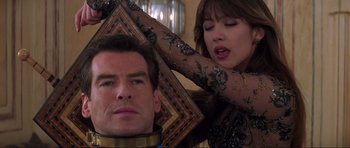 Movie still from “The World Is Not Enough” (1999), directed by Michael Apted – A man and a woman are combing each other's hair; Close Up shot, Over the shoulder angle