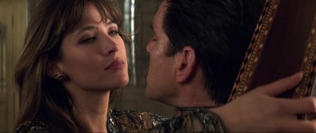 Movie still from “The World Is Not Enough” (1999), directed by Michael Apted – A man and a woman face to face in front of a mirror; Close Up shot, Low angle