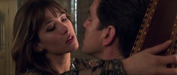 Movie still from “The World Is Not Enough” (1999), directed by Michael Apted – A man and a woman are kissing in a room; Close Up shot, Over the shoulder angle