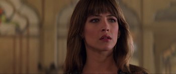 Movie still from “The World Is Not Enough” (1999), directed by Michael Apted – A person with long brown hair; Close Up shot, Over the shoulder angle