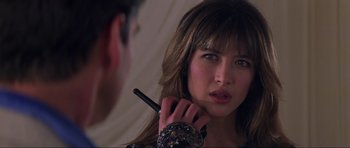 Movie still from “The World Is Not Enough” (1999), directed by Michael Apted – A woman is looking at her reflection in the mirror; Close Up shot, Over the shoulder angle