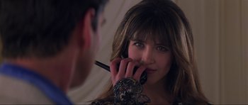 Movie still from “The World Is Not Enough” (1999), directed by Michael Apted – A woman is talking on a cell phone in front of a mirror; Close Up shot, Over the shoulder angle