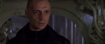 Movie still from “The World Is Not Enough” (1999), directed by Michael Apted – A person wearing a black jacket; Close Up shot, Low angle