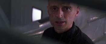 Movie still from “The World Is Not Enough” (1999), directed by Michael Apted – A person wearing a black sweater; Close Up shot, Low angle