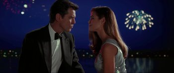 Movie still from “The World Is Not Enough” (1999), directed by Michael Apted – A man and a woman in formal wear looking at each other; Medium shot, Low angle