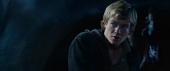 Movie still from “Eragon” (2006), directed by Stefen Fangmeier – A man with blonde hair and blue eyes stares into the camera; Close Up shot, Low angle