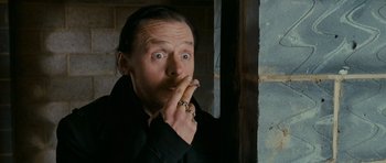 Movie still from “The World's End” (2013), directed by Edgar Wright – A man in a black jacket is smoking a cigarette; Close Up shot, Low angle