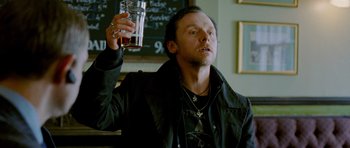 Movie still from “The World's End” (2013), directed by Edgar Wright – A man holding a glass of beer in his right hand; Close Up shot, Low angle