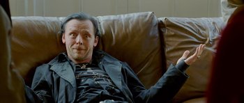 Movie still from “The World's End” (2013), directed by Edgar Wright – A man sitting on a couch with his arm up; Close Up shot, High angle