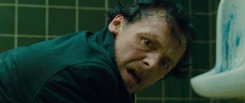 Movie still from “The World's End” (2013), directed by Edgar Wright – A person in a green shirt; Close Up shot, Over the shoulder angle