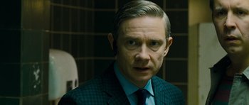 Movie still from “The World's End” (2013), directed by Edgar Wright – A person wearing a suit and tie; Close Up shot, Over the shoulder angle