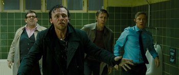 Movie still from “The World's End” (2013), directed by Edgar Wright – A group of people standing in a bathroom; Medium shot, Low angle