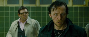 Movie still from “The World's End” (2013), directed by Edgar Wright – Two men in a bathroom one is wearing glasses and the other is wearing a jacket; Close Up shot, Over the shoulder angle