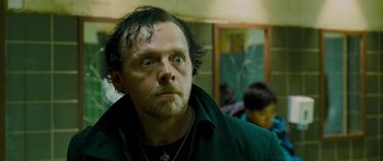 Movie still from “The World's End” (2013), directed by Edgar Wright – A person wearing a green jacket; Close Up shot, Low angle