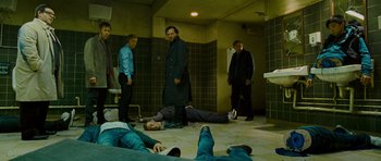 Movie still from “The World's End” (2013), directed by Edgar Wright – A group of men standing in a bathroom next to each other; Wide shot, High angle