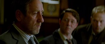 Movie still from “The World's End” (2013), directed by Edgar Wright – Two men in business suits sitting next to each other; Close Up shot, Over the shoulder angle