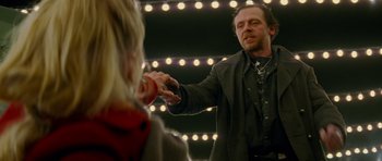 Movie still from “The World's End” (2013), directed by Edgar Wright – A man holding a woman's hand in front of a mirror; Medium shot, Over the shoulder angle