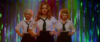 Movie still from “The World's End” (2013), directed by Edgar Wright – A group of women standing next to each other; Medium shot, Low angle