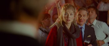 Movie still from “The World's End” (2013), directed by Edgar Wright – A woman in a red coat and a gray scarf; Close Up shot, Over the shoulder angle