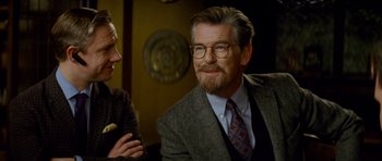 Movie still from “The World's End” (2013), directed by Edgar Wright – An older man wearing glasses and a suit; Close Up shot, Over the shoulder angle