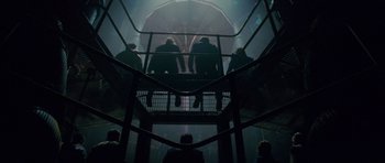 Movie still from “The World's End” (2013), directed by Edgar Wright – A group of people sitting on top of a metal structure; Wide shot, Low angle