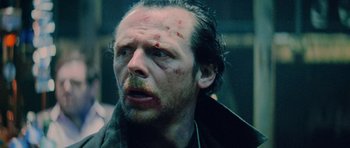 Movie still from “The World's End” (2013), directed by Edgar Wright – A person with blood on his face; Close Up shot, Over the shoulder angle
