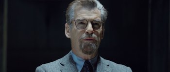 Movie still from “The World's End” (2013), directed by Edgar Wright – An older man wearing a suit and glasses; Close Up shot, Over the shoulder angle