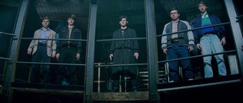 Movie still from “The World's End” (2013), directed by Edgar Wright – A group of men standing next to each other in a building; Wide shot, Low angle