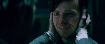 Movie still from “The World's End” (2013), directed by Edgar Wright – A person with his hand up to his ear; Close Up shot, Over the shoulder angle