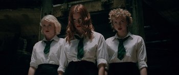 Movie still from “The World's End” (2013), directed by Edgar Wright – A group of three women standing next to each other; Medium shot, Low angle