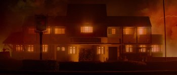 Movie still from “The World's End” (2013), directed by Edgar Wright – A building lit up at night in a dark place; Extreme Wide shot, High angle