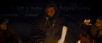 Movie still from “The World's End” (2013), directed by Edgar Wright – A man sitting in the dark by a fire; Medium shot, Low angle