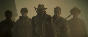Movie still from “The World's End” (2013), directed by Edgar Wright – A group of men standing next to each other in the fog; Medium shot, Low angle